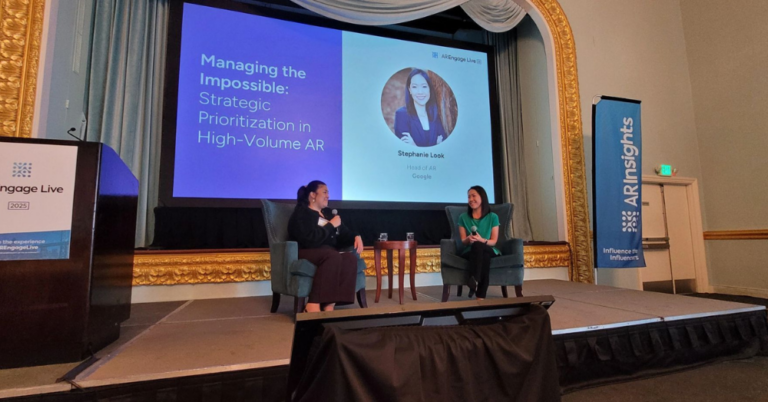 Two women sit in armchairs on a stage during a panel discussion at an ARInsights event.