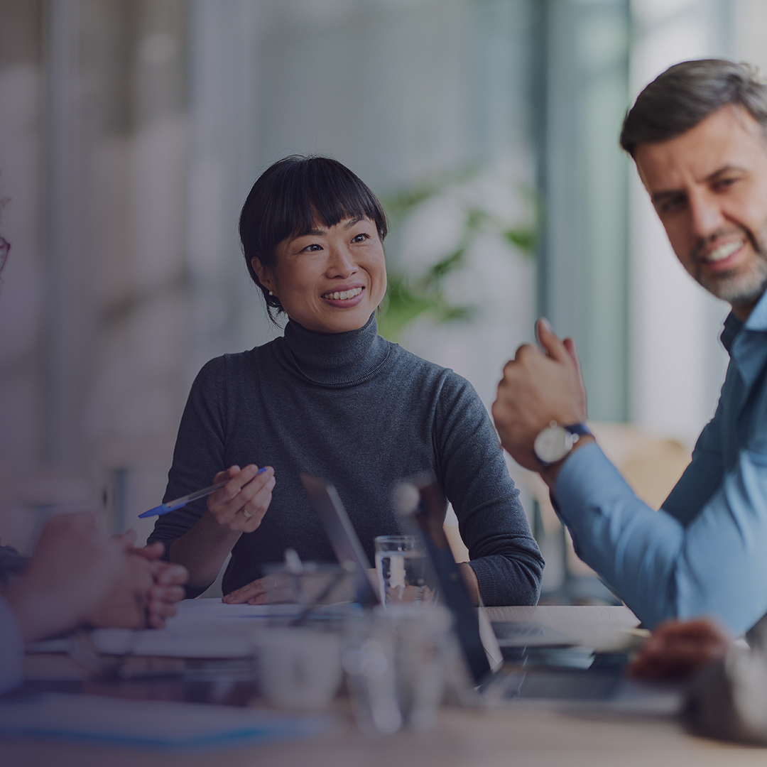 Photo of group of people meeting around conference table