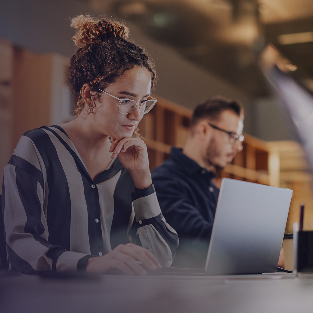 Photo of woman focused at computer
